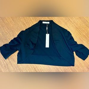 Belle Pogue Size small Black Shrug. New with tags.
